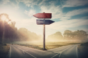 Stock image of a cross-roads with sign posts pointing both directions